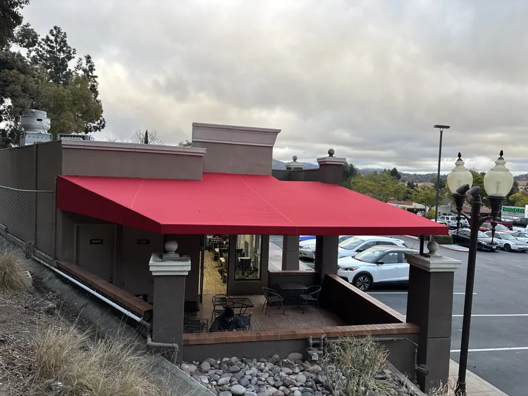 Red awning covering a restaurant patio