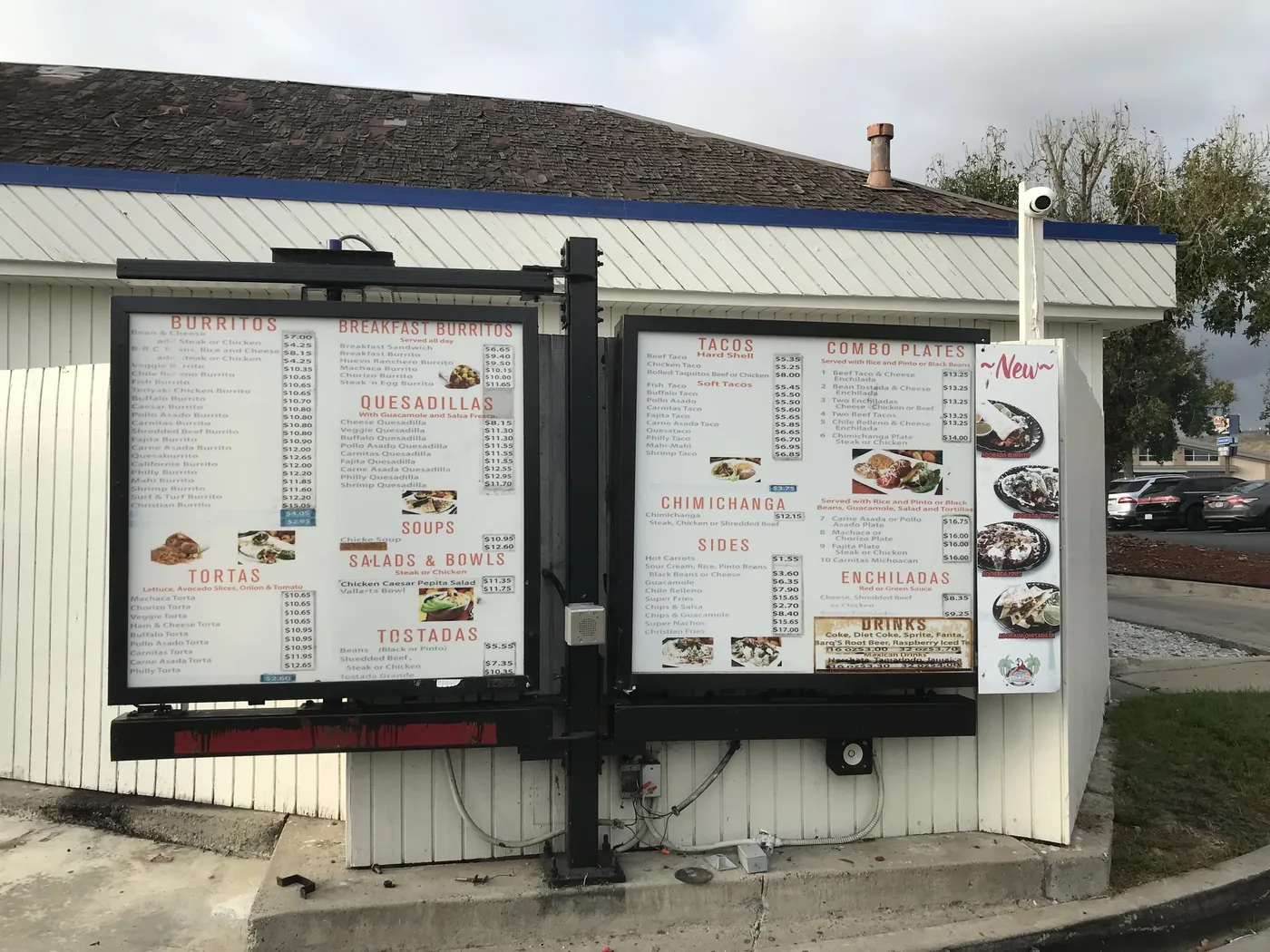 Two drive-through menu boards at a taco shop