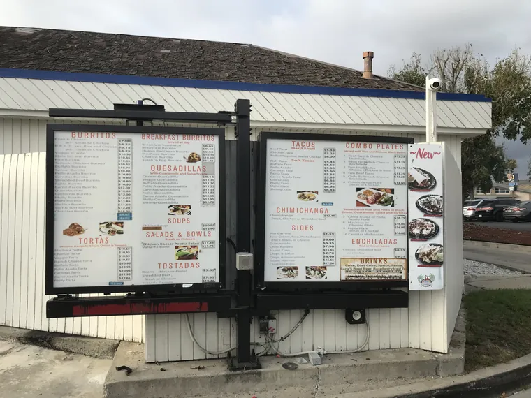 Two drive-through menu boards at a taco shop