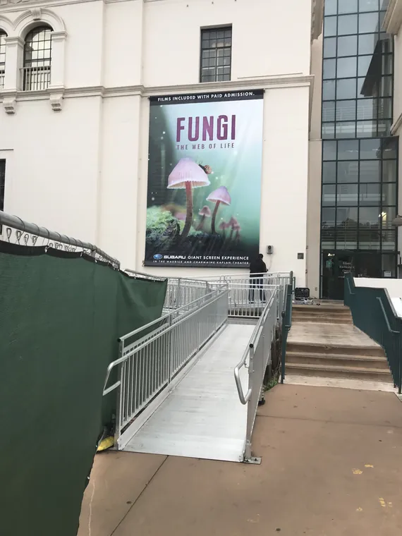 Fungi exhibit banner on a museum wall