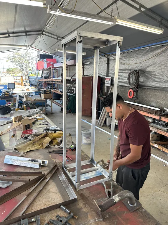 Building the metal frame of a sign in the shop