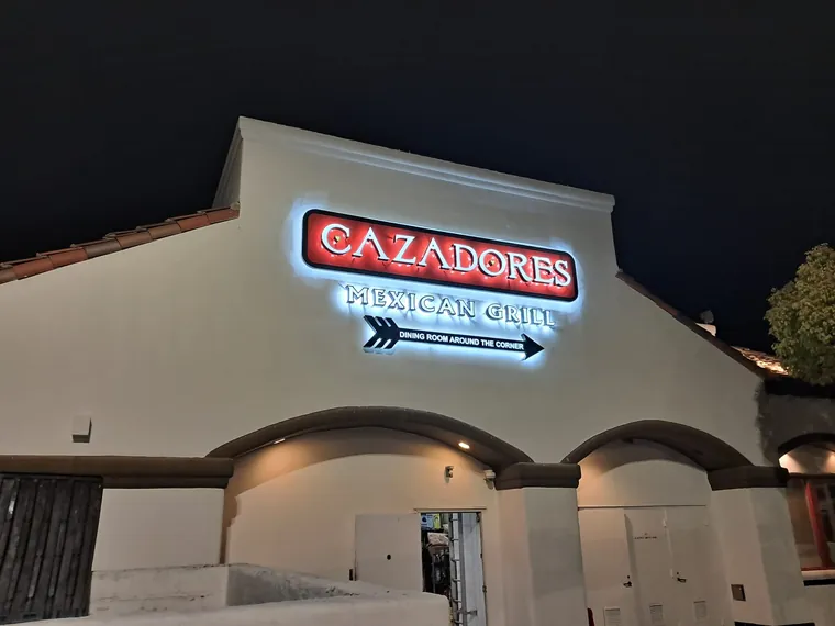 Cazadores Mexican Grill illuminated storefront sign at night