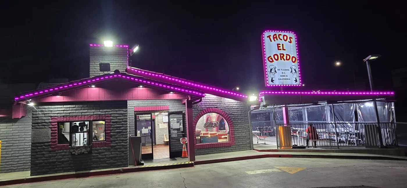 Tacos El Gordo building and pole sign with purple LED accent lighting