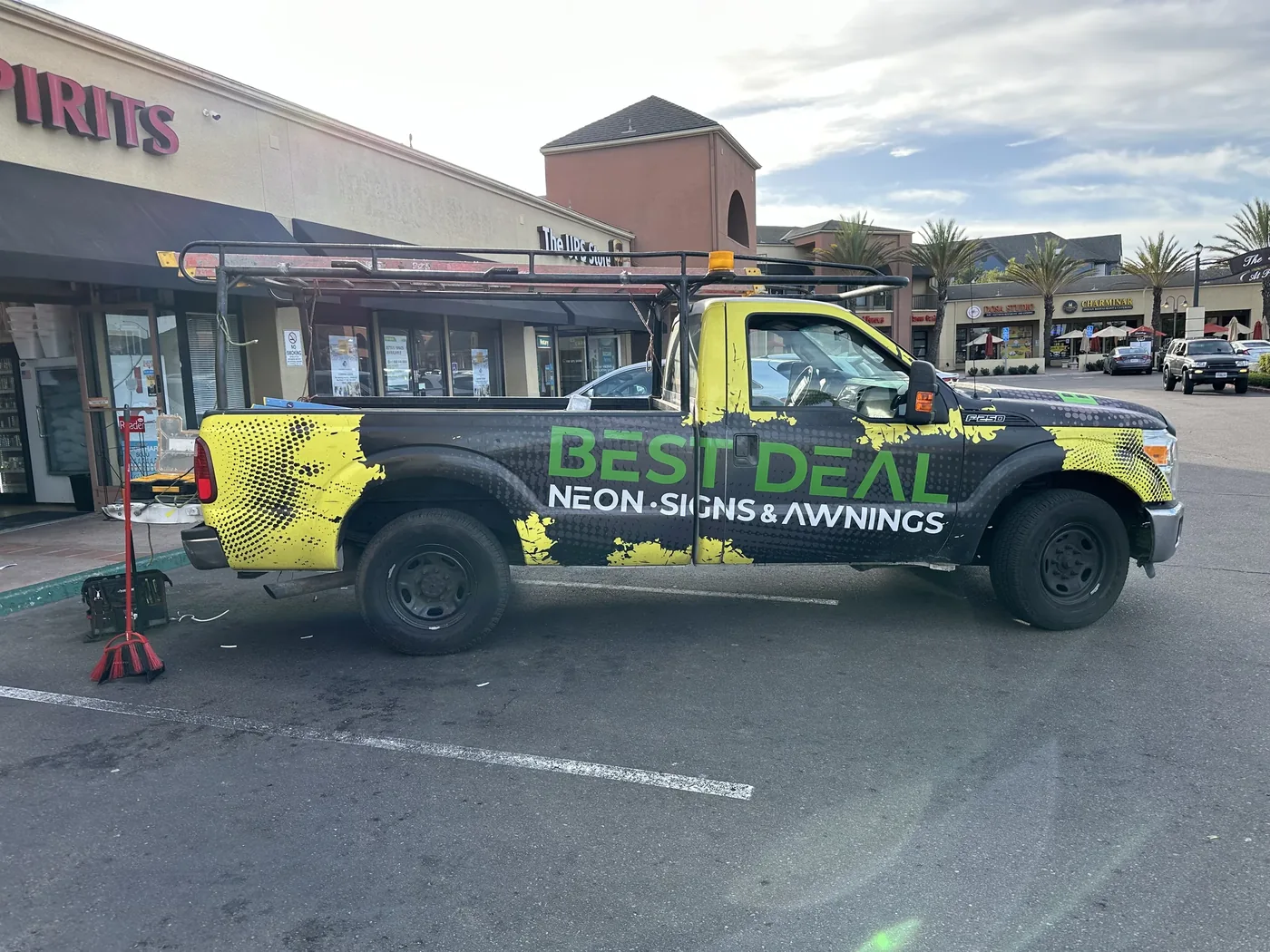 Best Deal work truck with green and black graphics