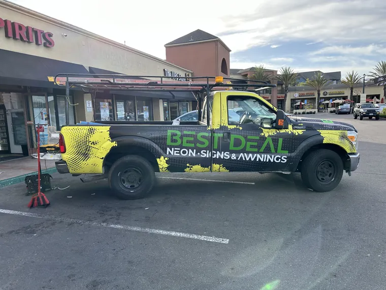 Best Deal work truck with green and black graphics