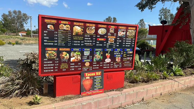 Red freestanding restaurant menu board