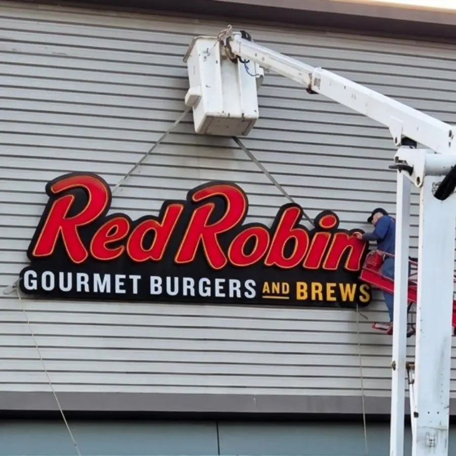 Red Robin Gourmet Burgers and Brews channel letters being installed from a bucket truck
