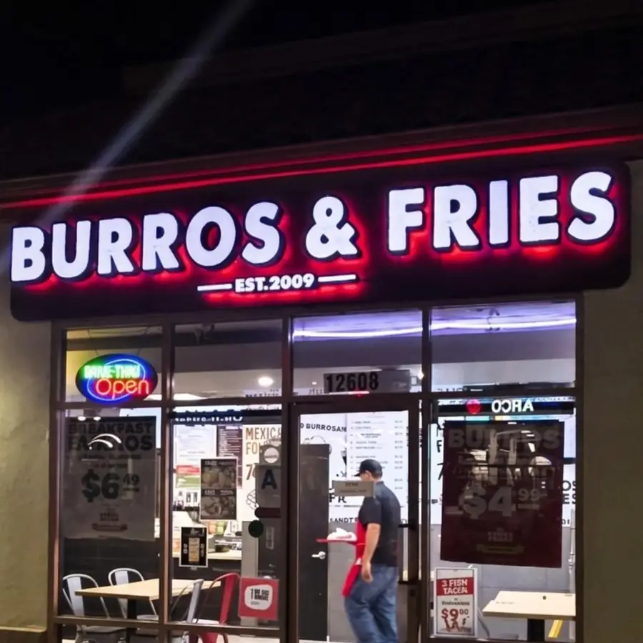 Burros and Fries illuminated storefront sign at night