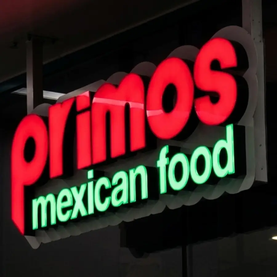 Primos Mexican Food channel letters glowing at night