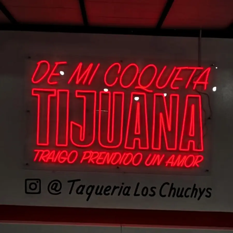 Red De Mi Coqueta Tijuana neon sign for Taqueria Los Chuchys