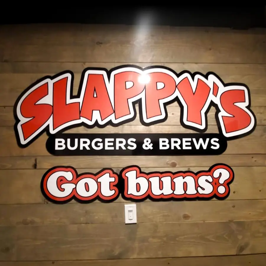 Slappys Burgers and Brews Got Buns dimensional sign on a wood wall