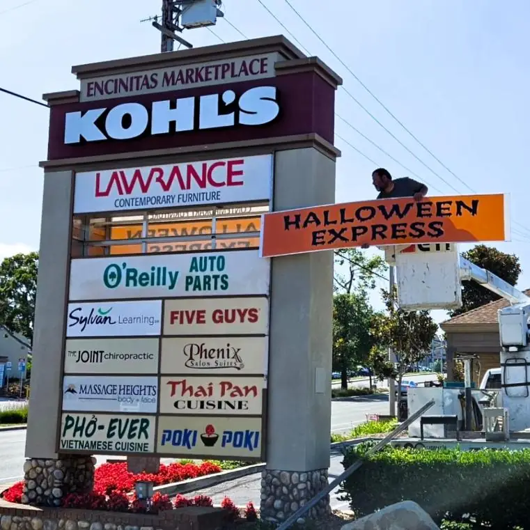 Encinitas Marketplace pylon sign with Kohls and tenant panels being serviced