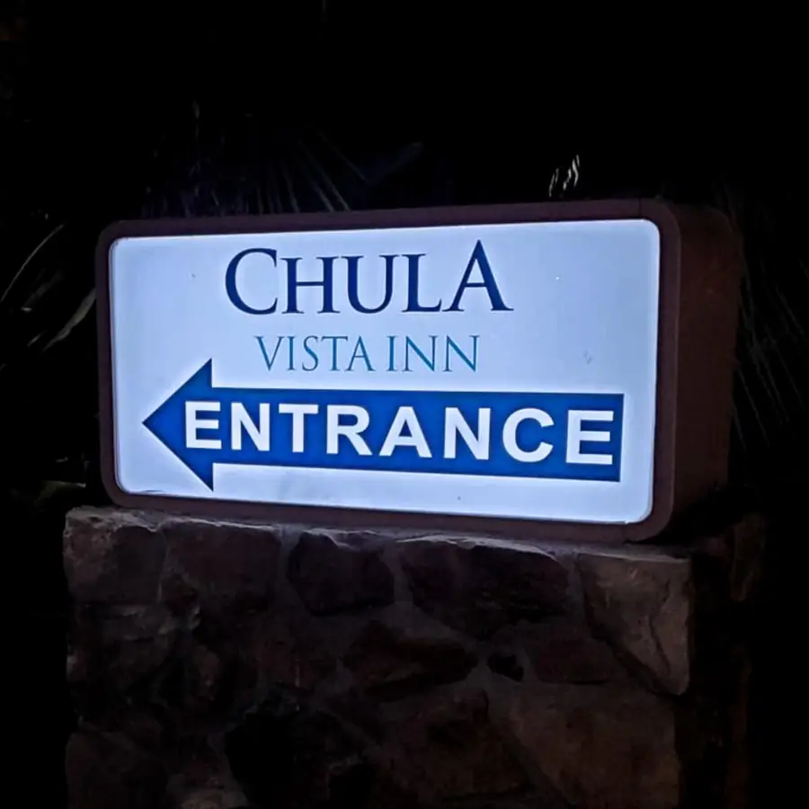 Chula Vista Inn lit entrance sign on a stone base