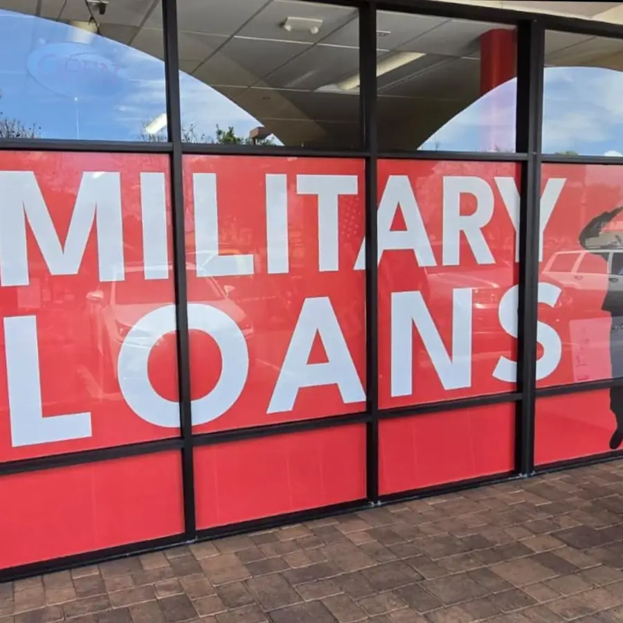 Finished Military Loans window graphics across a full storefront