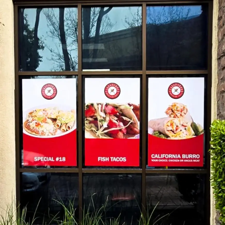 Printed food photo panels in a restaurant window