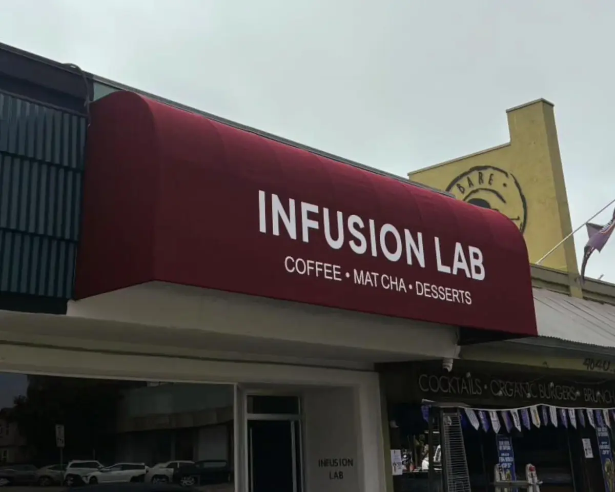 Dark red Infusion Lab awning over a coffee shop entrance