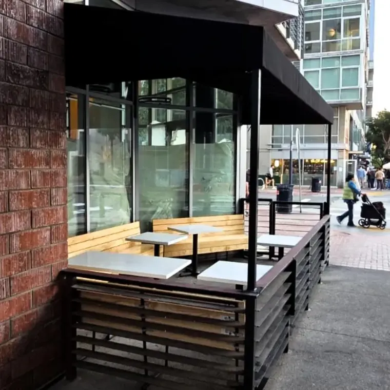 Black patio enclosure with slatted screens and bench seating