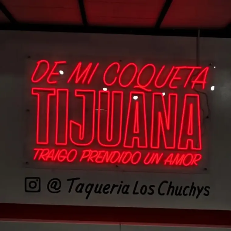 Red De Mi Coqueta Tijuana neon sign for Taqueria Los Chuchys